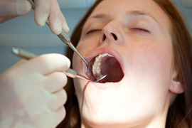 A woman getting her teeth cleaned by a Dentist in Keene